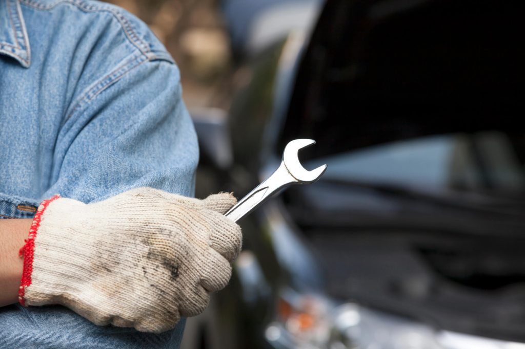 Closeup of a auto repair man holding a wrench European auto repair Davie FL