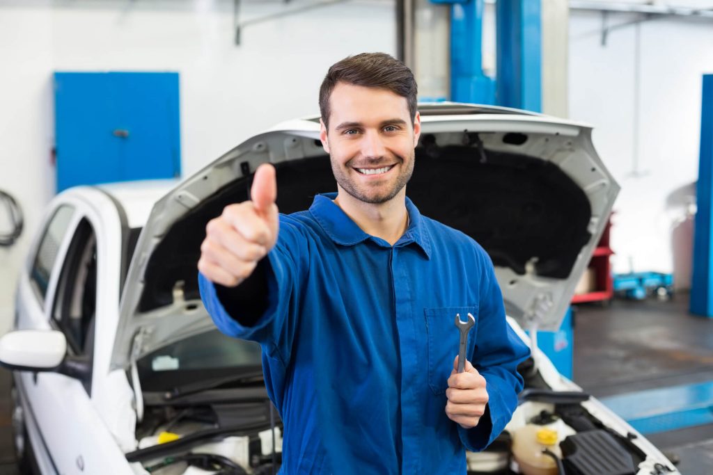 an expert in Volkswagen Repair in Davie FL giving a thumbs up sign
