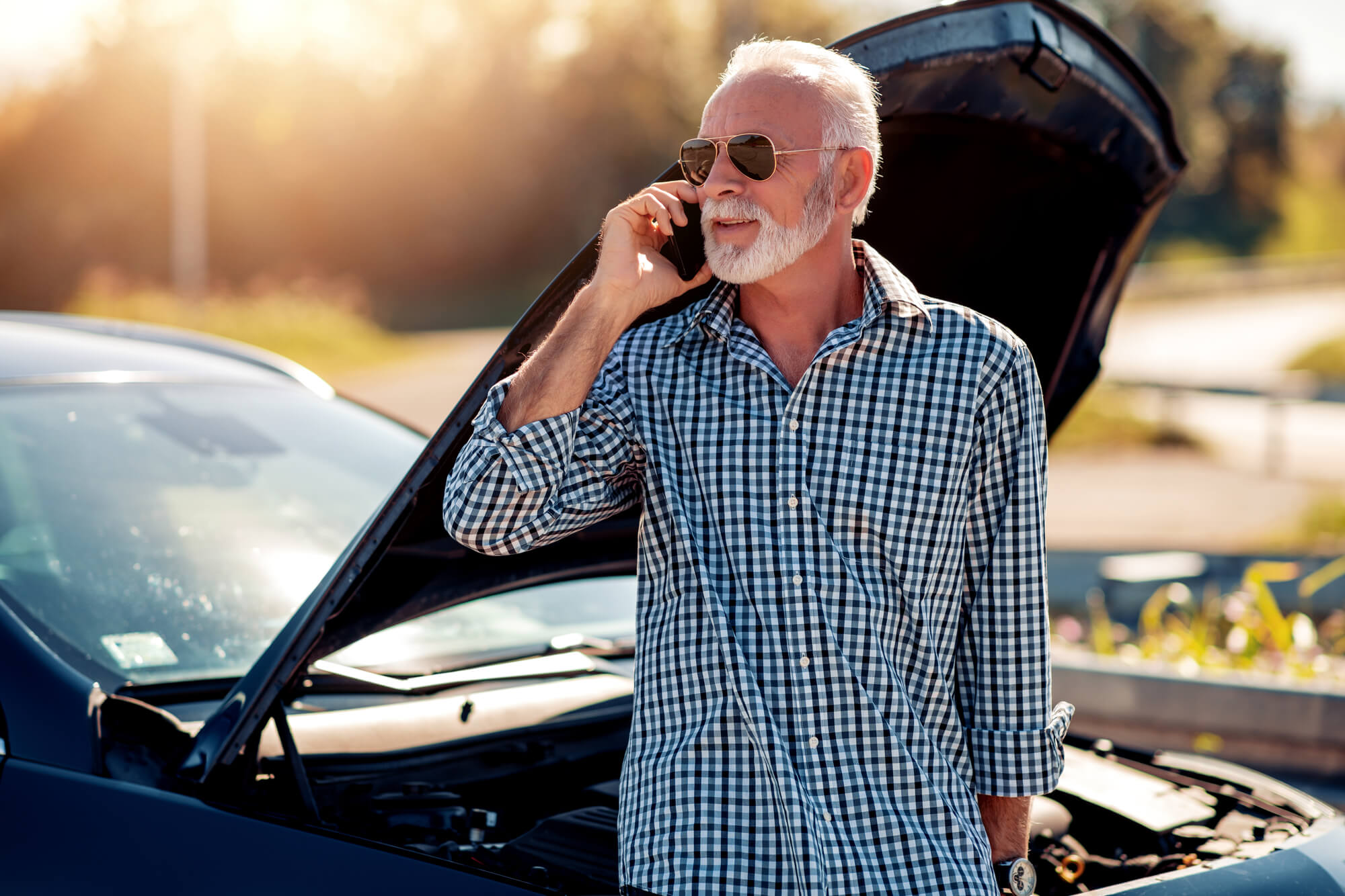 a man having car trouble needing help from an expert in Foreign Auto Repair in Davie FL