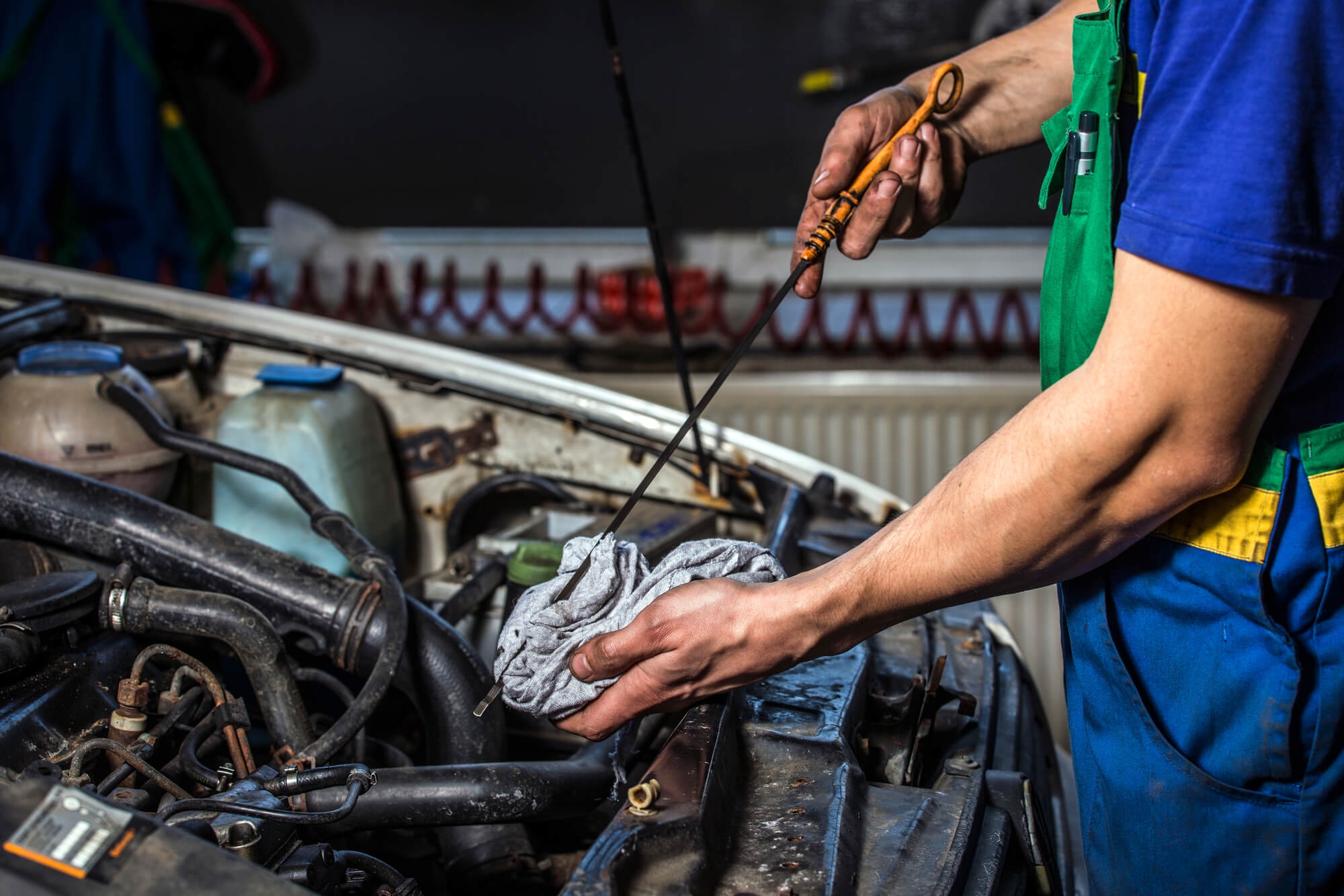 expert checking engine oil during Import auto repair Davie FL