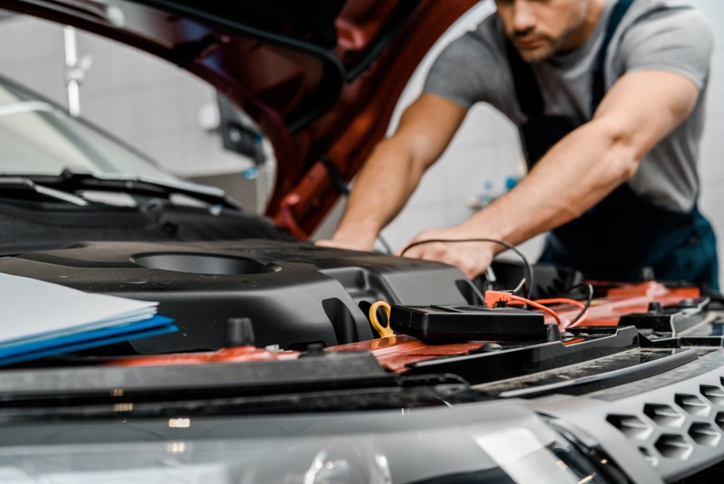 expert-fixing-car-battery-during-BMW-repair-in-Davie-FL