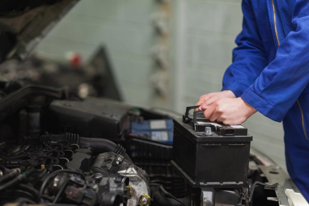 professional-fixing-car-battery-during-BMW-repair-in-Davie-FL