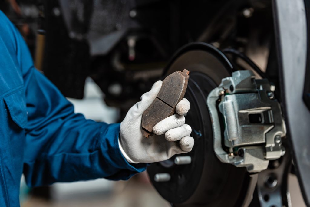 expert holding brake pad for Auto Repair Ft. Lauderdale FL